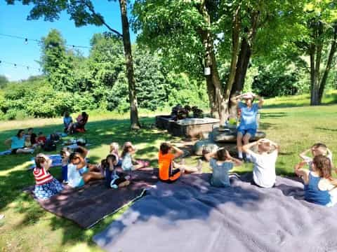 a group of people sitting on the grass