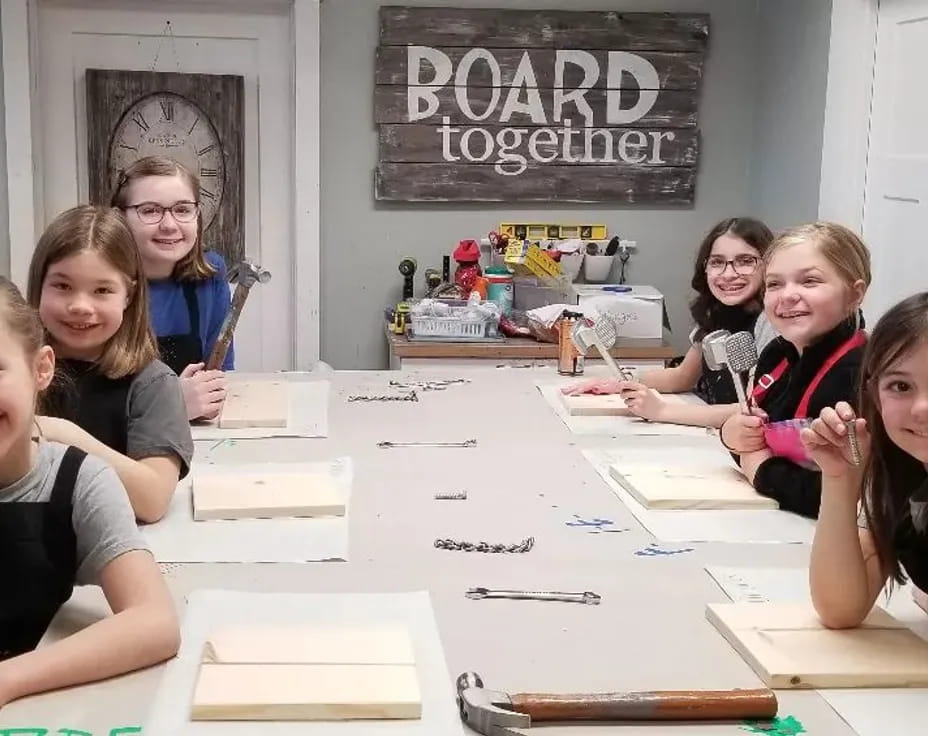 a group of girls sitting at a table