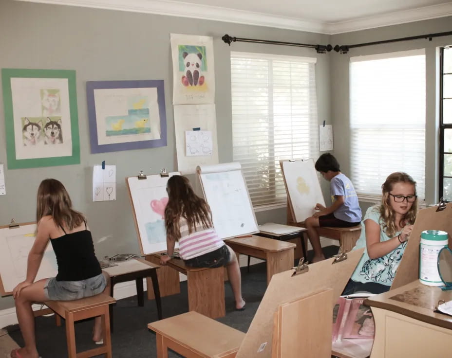 a group of people sitting at desks in a classroom