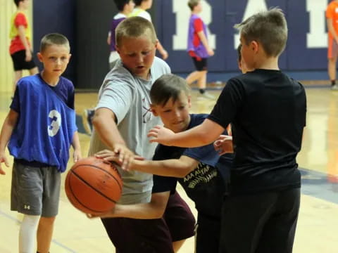 a group of kids playing basketball