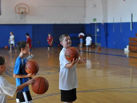 a group of kids playing basketball