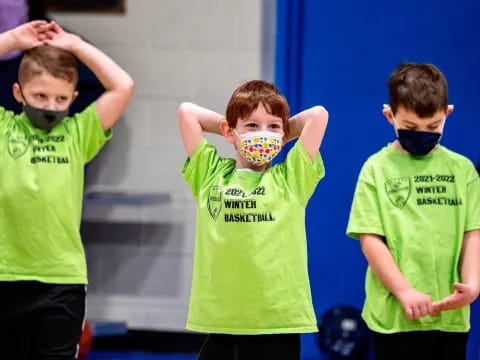 a group of boys wearing green shirts