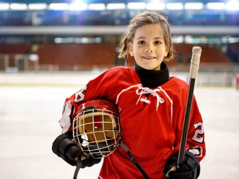 a girl holding a hockey stick
