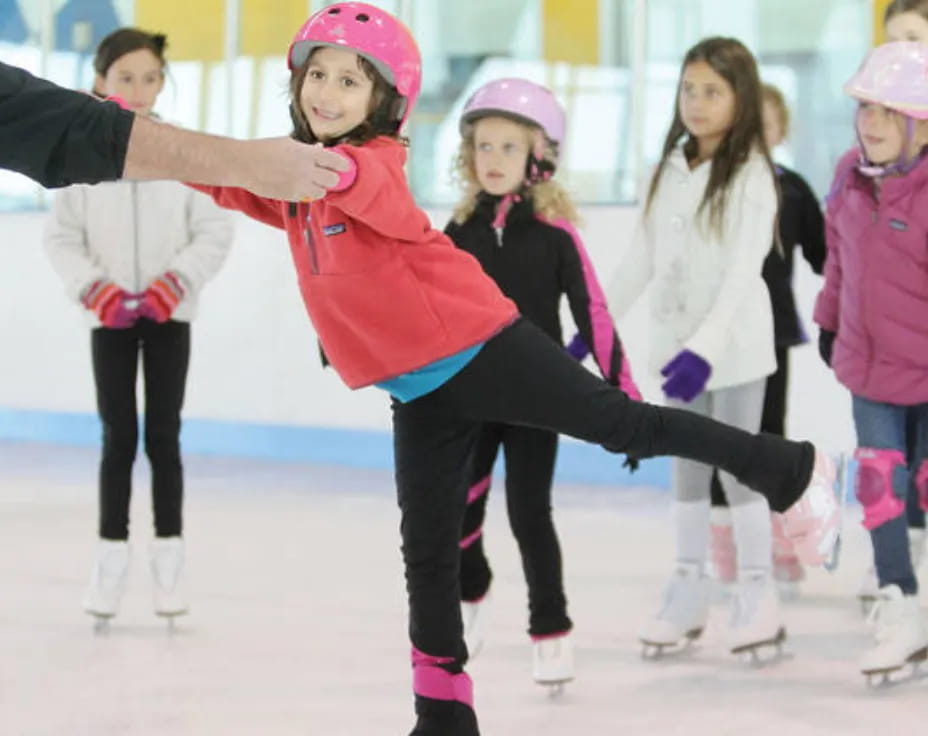 a group of people wearing ice skates and helmets