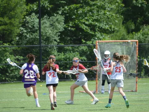 a group of women playing lacrosse