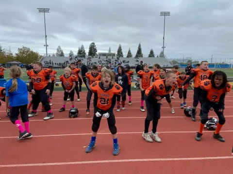 a group of people running on a track