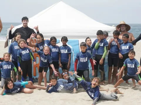 a group of people posing for a photo on a beach