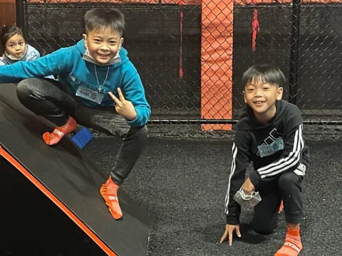 a group of boys sitting on a trampoline