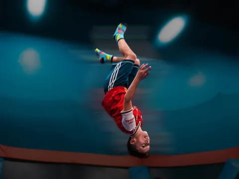 a person in a red and white uniform jumping in the air