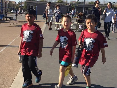 a group of boys in red shirts