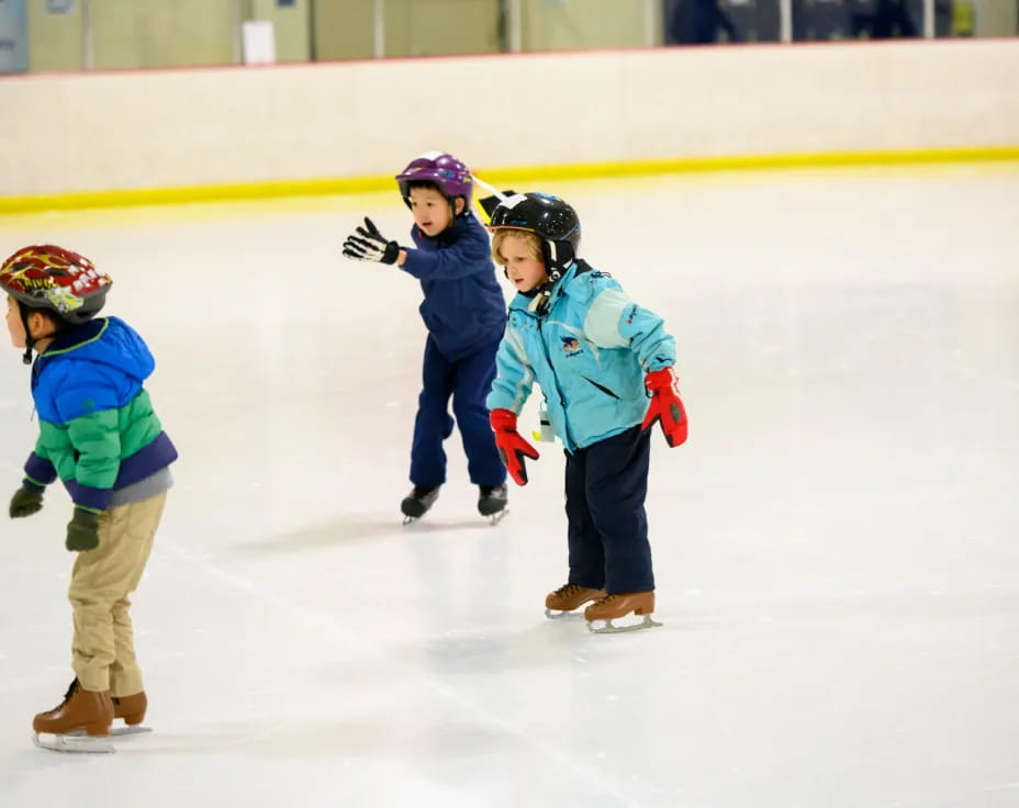 a group of kids on an ice rink