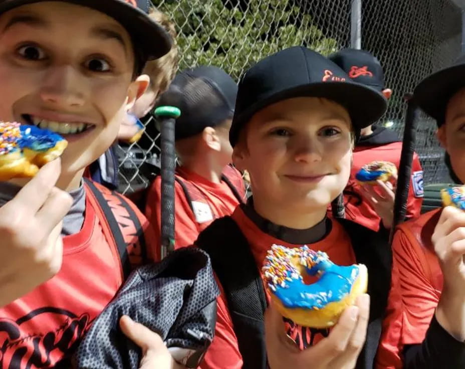 a group of kids eating donuts