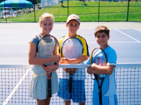 a group of boys holding tennis rackets