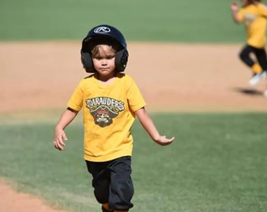 a boy running on a baseball field