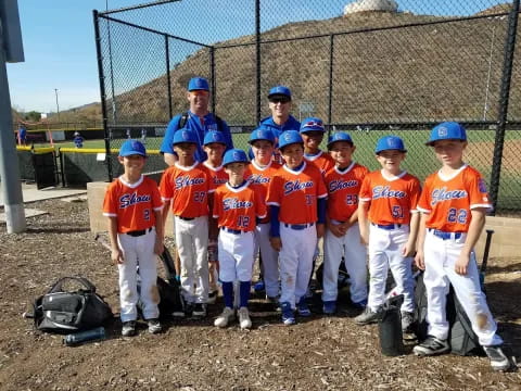 a group of kids in baseball uniforms
