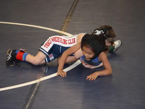 a couple of women wrestling on a court