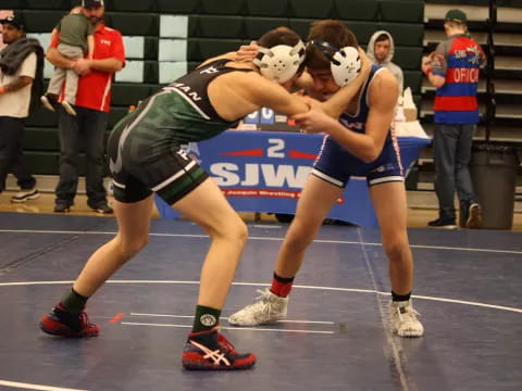 two women wrestling on a court