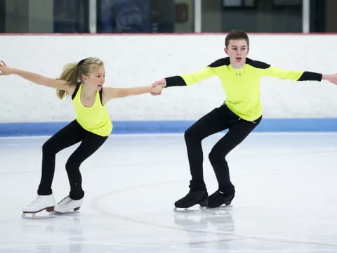 a man and a woman ice skating