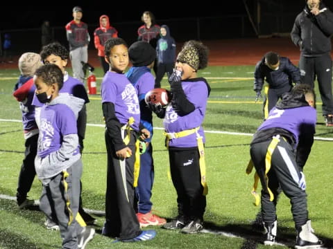 a group of kids playing football