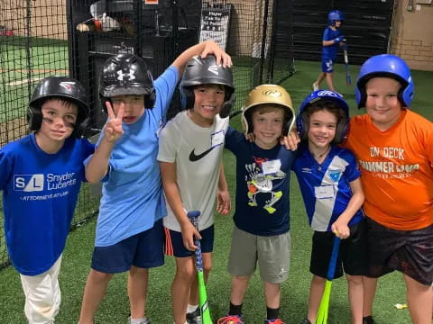 a group of kids wearing helmets and holding hockey sticks