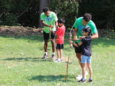 a group of people holding bows and arrows