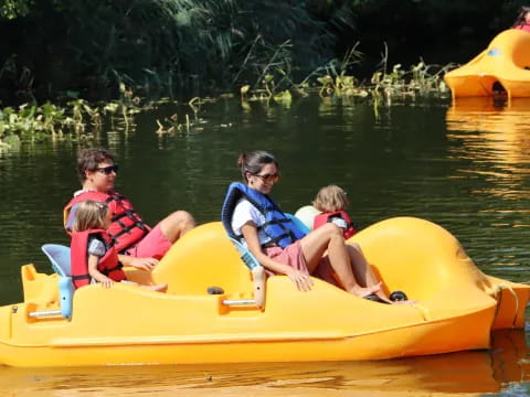 a group of people in a yellow boat on water