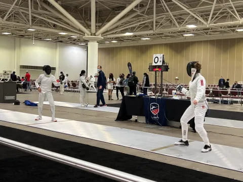 a group of people in white uniforms practicing martial arts