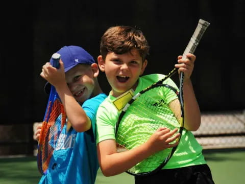 a couple of kids playing tennis