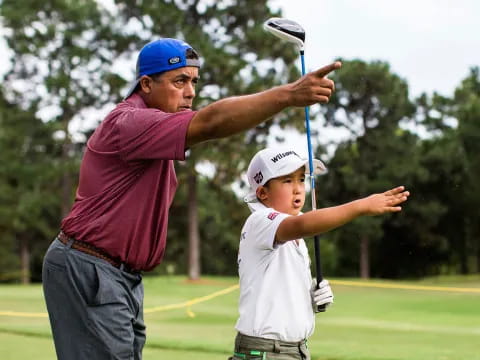 a man and a boy playing golf