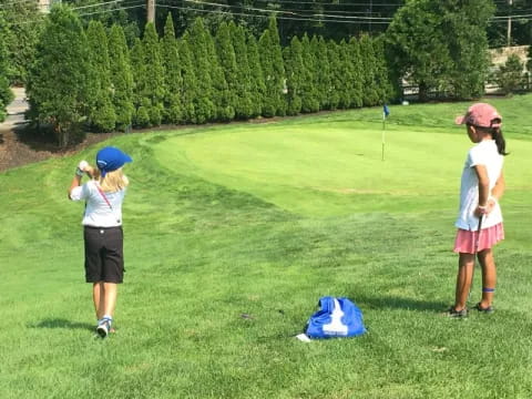 a couple of girls playing golf