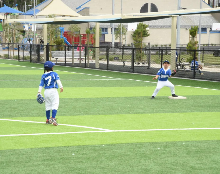 kids playing baseball on a field