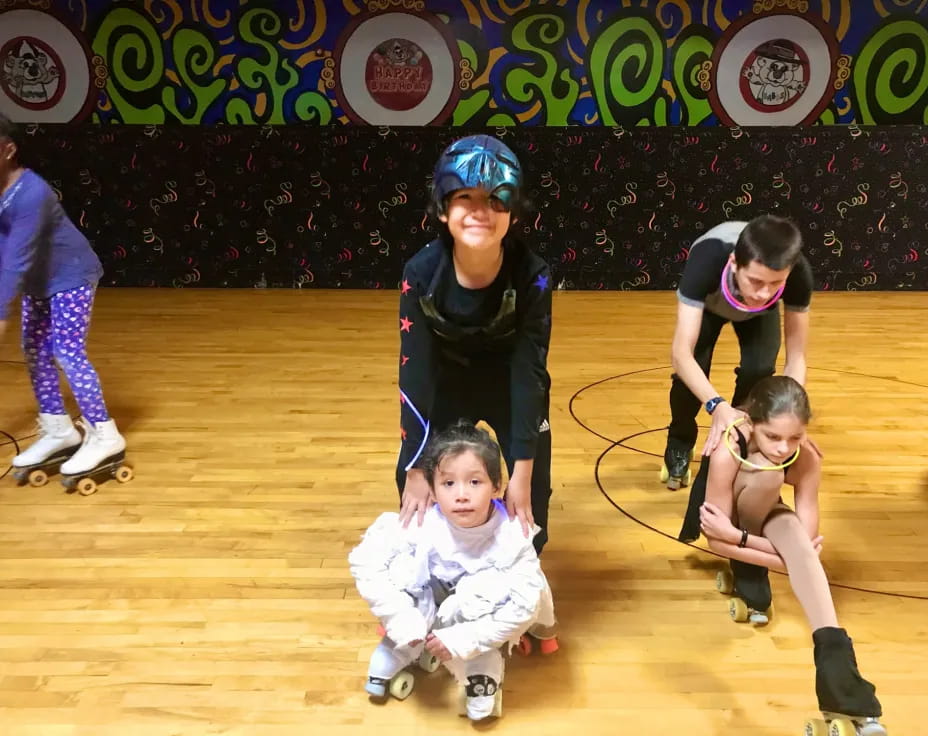 a group of kids wearing roller blades