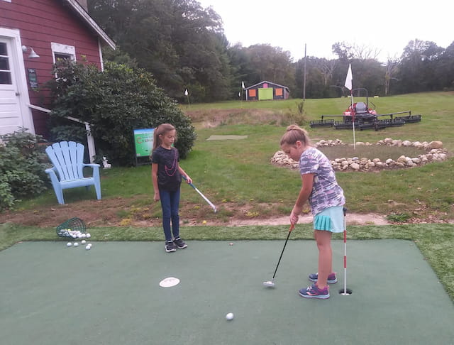 a couple of girls playing golf