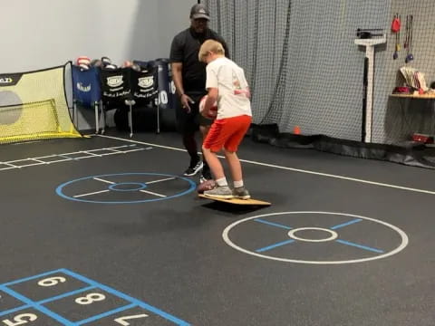 a boy standing on a mat