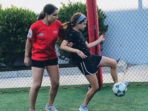 a couple of women playing football