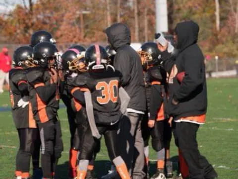 a group of football players standing on a field