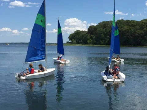 a group of people on small boats on water