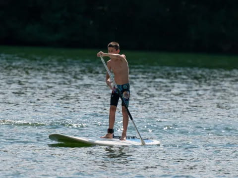 a man paddle boarding on a lake