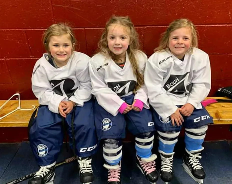 a group of girls wearing hockey uniforms