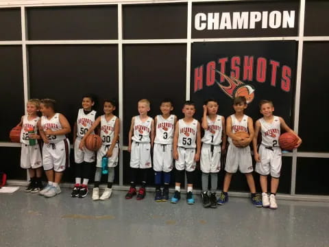 a group of kids in basketball uniforms
