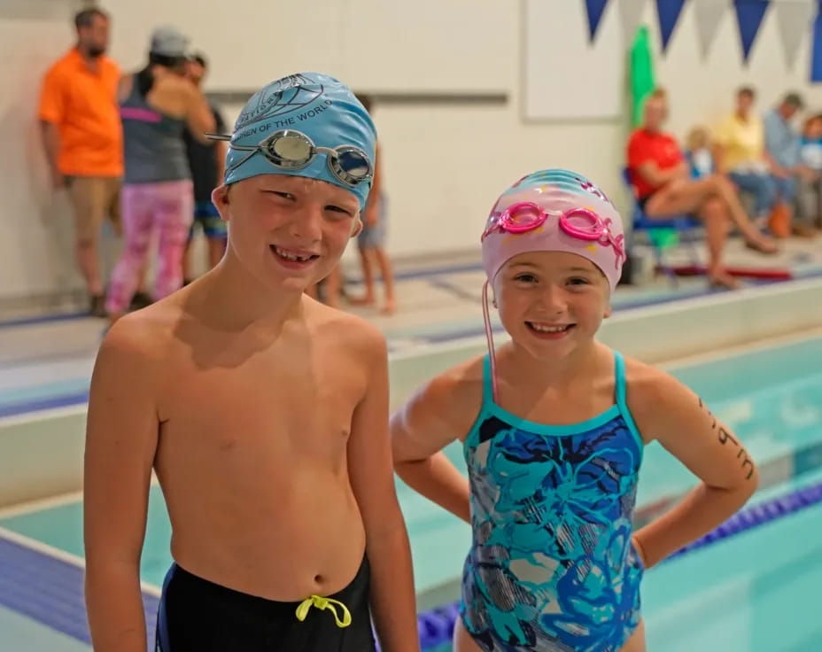 a boy and girl in swim gear