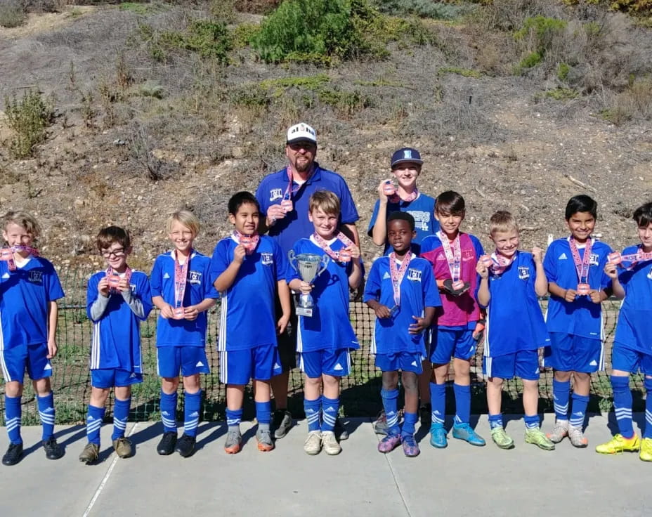 a group of kids in blue uniforms