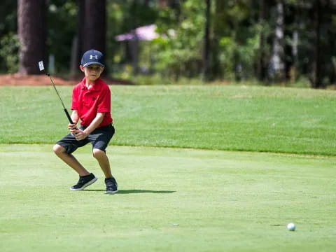 a boy playing golf