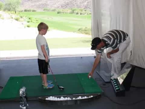 a man and a boy playing golf