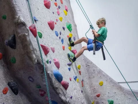a boy climbing a rock wall