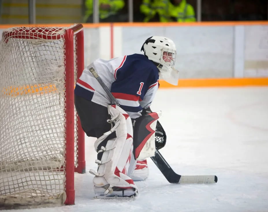 a hockey player in a white uniform