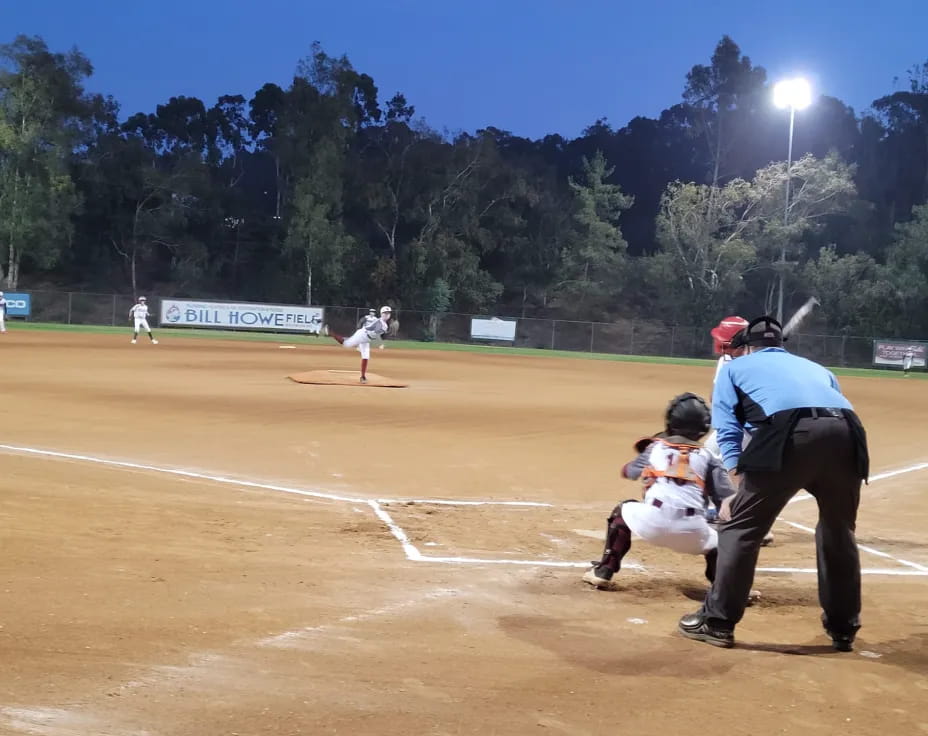 a baseball player swings a bat