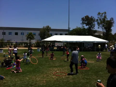 a group of people playing with hoops in a field