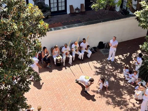 a group of people sitting on the ground outside