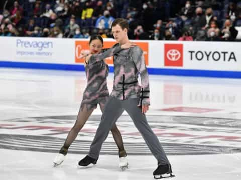 a man and woman ice skating